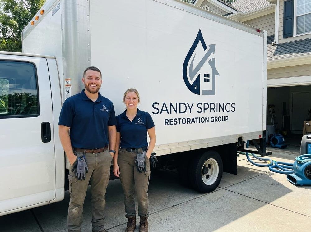 Sandy Springs Restoration Group commercial water damage restoration technicians beside a service truck
