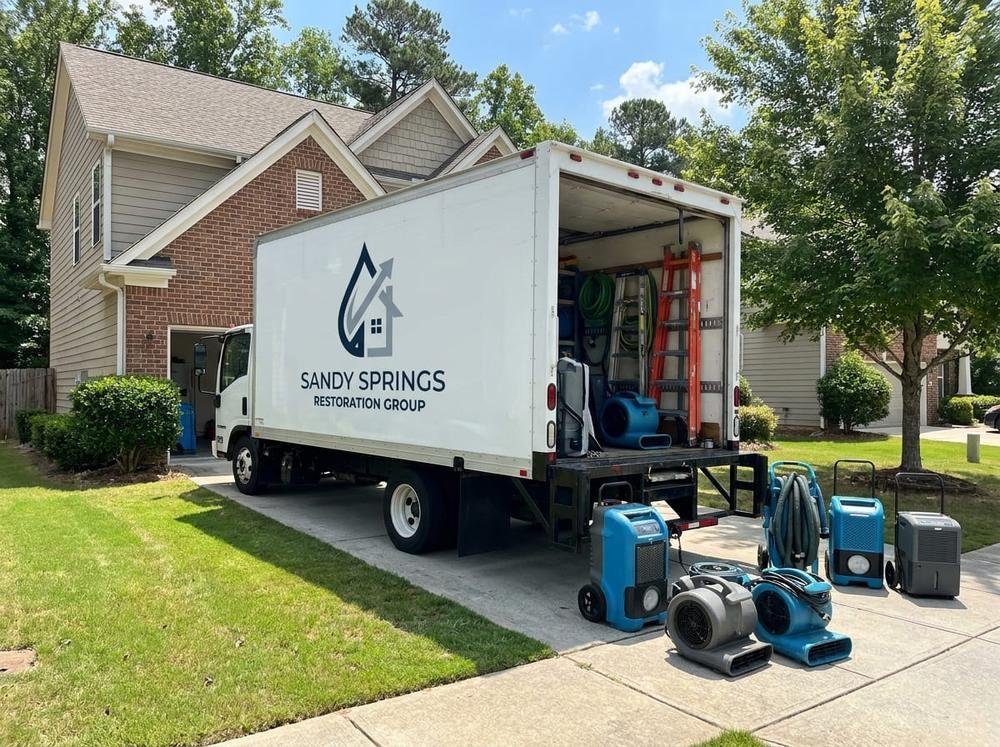 Sandy Springs Restoration Group emergency board-up and tarping service truck at a Sandy Springs, GA property
