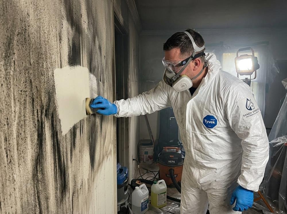 Technician performing smoke odor removal after fire damage in a Sandy Springs, GA home